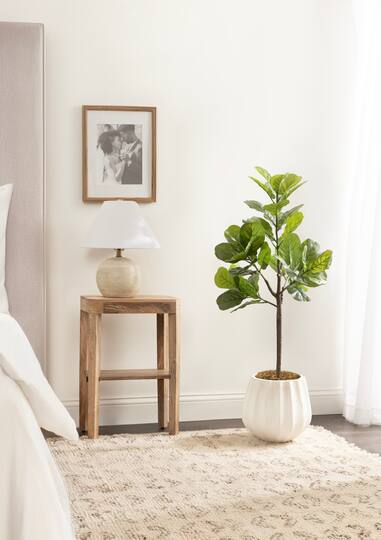 Kate and Laurel 4ft. Fidmont Faux Fiddle Fig Tree in Claudel Scalloped Planter